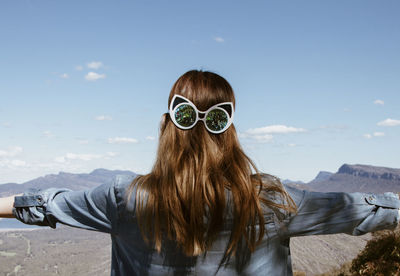 Portrait of woman wearing sunglasses against sky