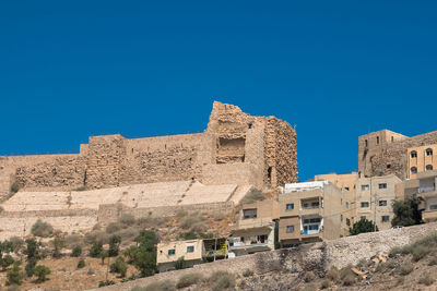 Low angle view of historical building against blue sky