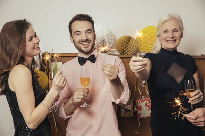 Friends celebrating new year's eve together, drinking champagne