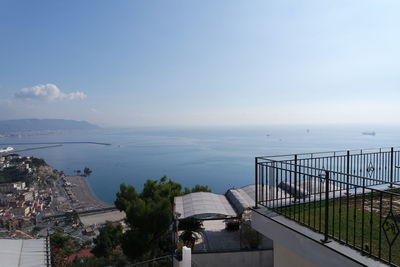 High angle view of buildings and sea against sky