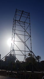 Low angle view of crane against clear sky
