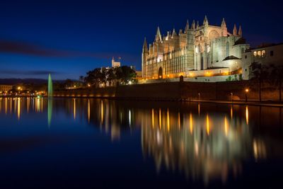 Reflection of buildings in water at night