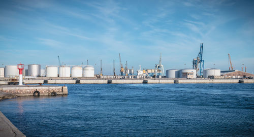 View of harbor by sea against sky