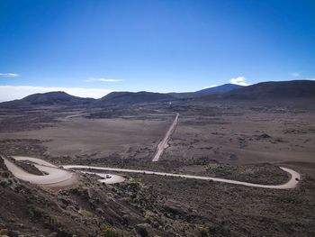 Scenic view of desert against blue sky