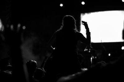 Rear view of silhouette people at music concert