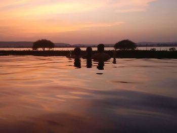 Scenic view of lake against sky during sunset