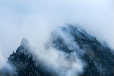 Scenic view of mountains during foggy weather
