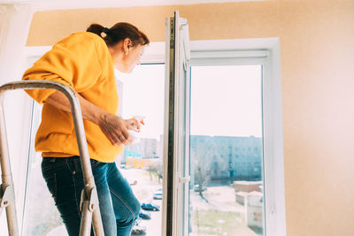 Rear view of man working at home