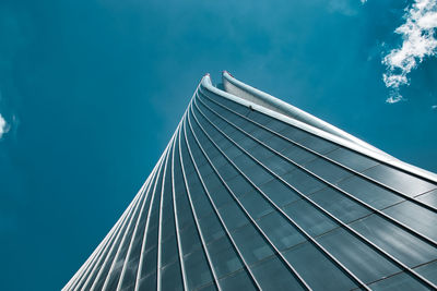 Low angle view of modern building against blue sky