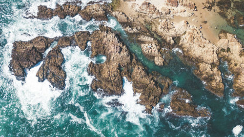 High angle view of rock formations in sea