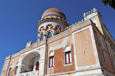 Low angle view of historic building against clear blue sky