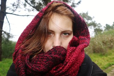 Portrait of young woman in park during winter
