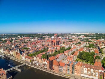 High angle view of illuminated buildings against blue sky