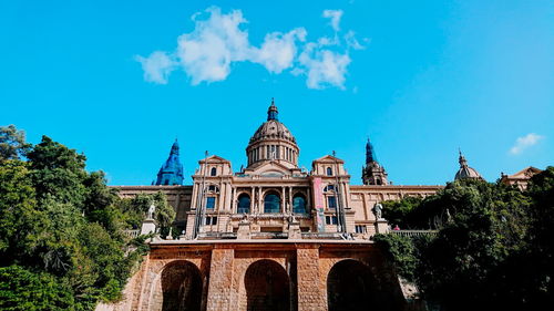 Low angle view of historic building against blue sky