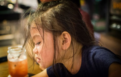 Close-up of girl in jar on table