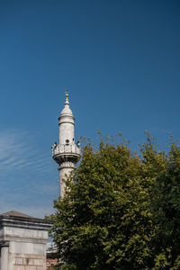 Low angle view of lighthouse against clear blue sky