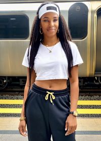 Portrait of young woman standing in train