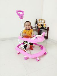 Portrait of cute baby girl on floor