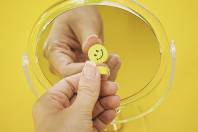 Cropped hand of woman holding thermometer