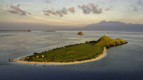 Scenic view of sea and mountains against sky