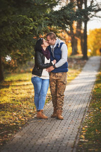 Full length of couple on footpath