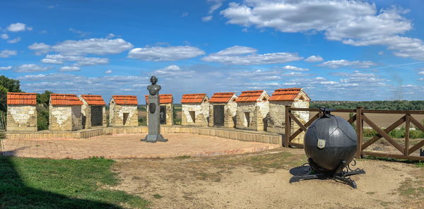 Old ruin on field against cloudy sky