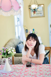 Portrait of cute girl sitting at home