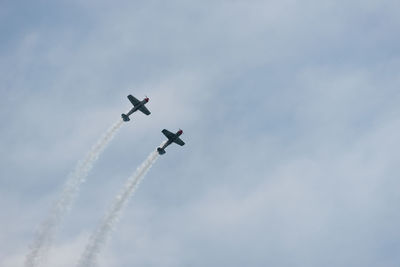 Low angle view of airshow against sky