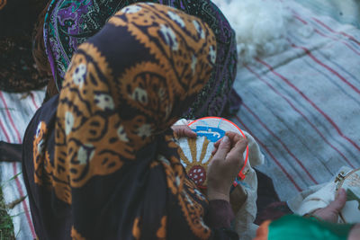 High angle view of woman with embroidery ring