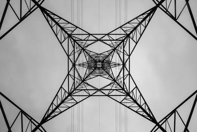 Low angle view of electricity pylon against sky