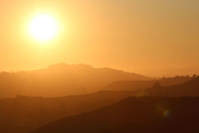 Scenic view of silhouette mountains against sky during sunset