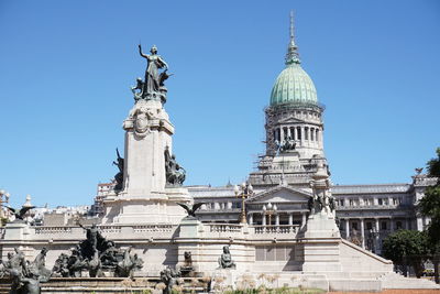 Low angle view of building against clear blue sky