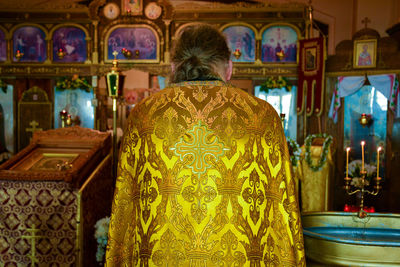 Rear view of man standing in temple