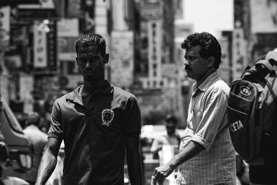 Men standing on street in city