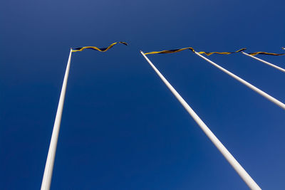 Low angle view of street light against clear blue sky