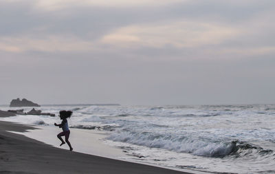 Man on beach against sky