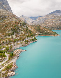 Scenic view of sea and mountains against sky