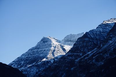 Scenic view of snowcapped mountains against clear blue sky