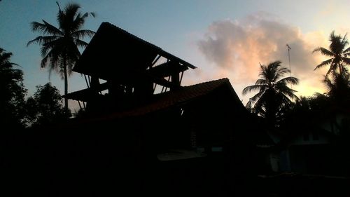 Low angle view of silhouette palm trees against sky