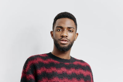 Portrait of young man against white background