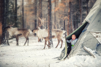 Full length of woman walking on snow covered land