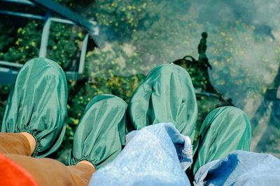 Low section of people relaxing by water