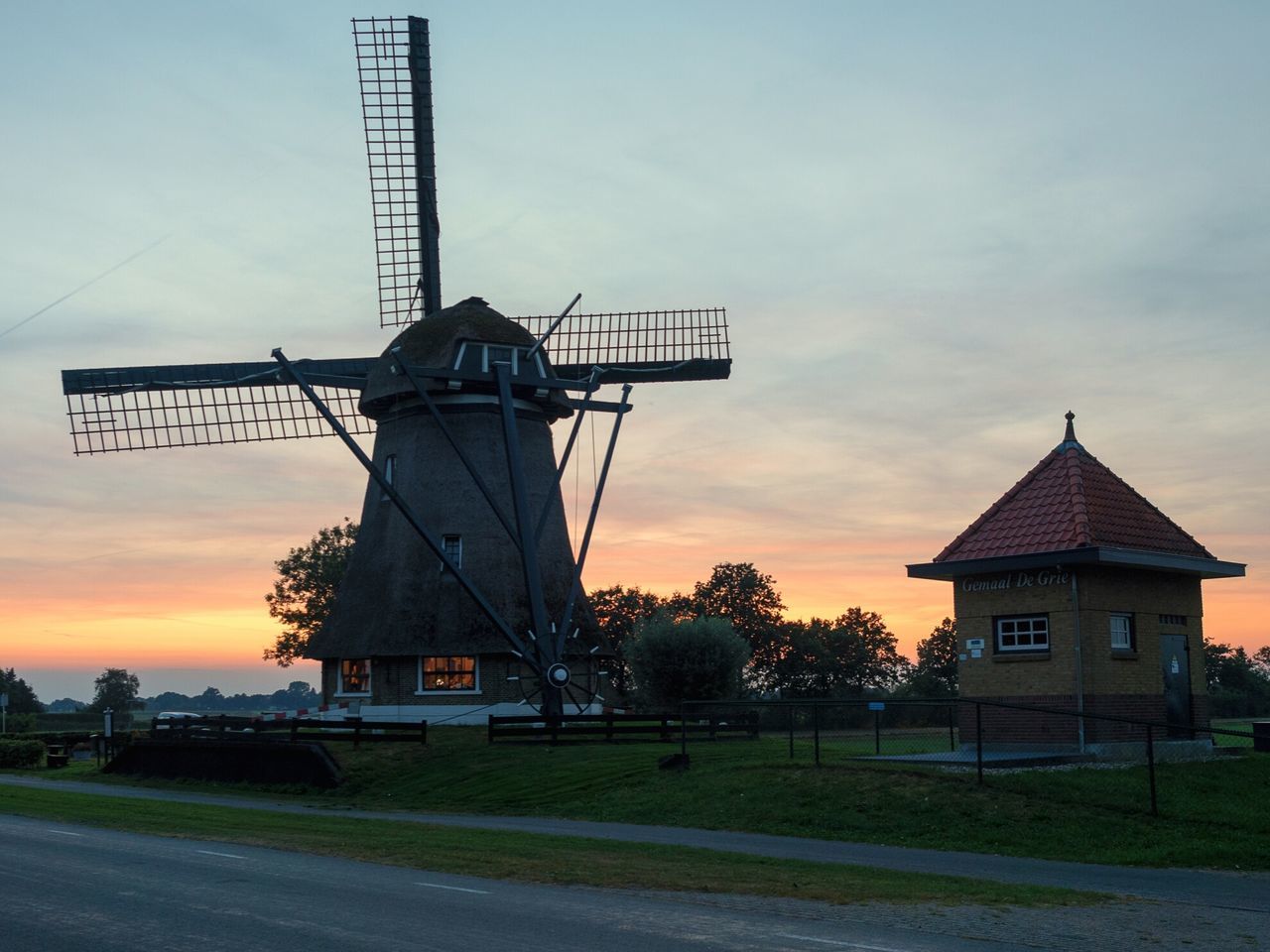 TRADITIONAL WINDMILL ON FIELD AGAINST SKY