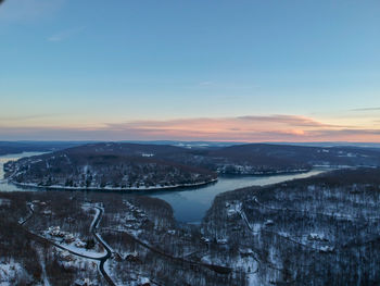 High angle view of snow covered landscape during sunset