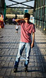 Portrait of young man standing on pier