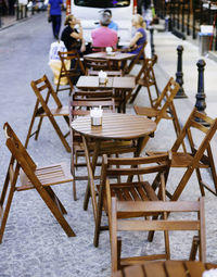 Wooden chairs by table at sidewalk cafe