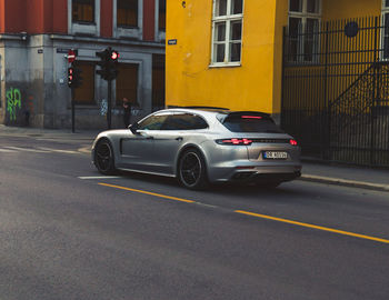 Car on road against buildings