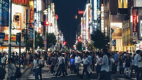 Crowd on illuminated tokyo street at night