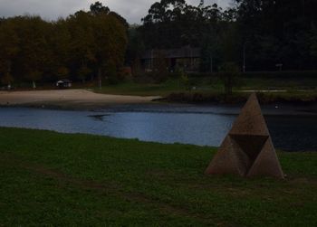 Scenic view of lake by trees against sky