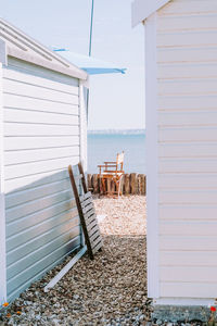 Chair on beach against sky